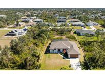 Aerial view of a single-Gathering home with a large backyard and surrounding houses at 7442 Clearwater St, Englewood, FL 34224