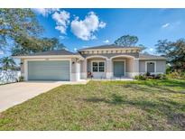 Newly constructed one-story home with attached garage and landscaped yard at 1312 Wasilla St, North Port, FL 34291