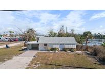 Charming single-story home with a covered parking area, and a water view at 1495 New Point Comfort Rd, Englewood, FL 34223