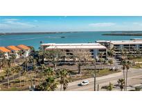 Aerial view of waterfront community with lush landscaping and parking at 1501 Beach Rd # 209, Englewood, FL 34223