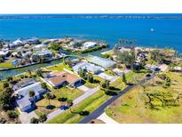 Waterfront home boasting lush landscaping, ample parking, and stunning water views at 275 North Dr, Englewood, FL 34223