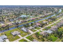 Expansive aerial view of a waterfront community with lush landscaping, canals, and single-Gathering homes at 604 Boundary Blvd, Rotonda West, FL 33947