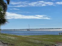 Scenic waterfront view with a sailboat on sparkling water and clear skies at 11000 Placida Rd # 101, Placida, FL 33946