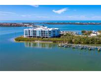 Waterfront condo featuring a private dock, lush greenery, and stunning views of the Gulf at 1375 Beach Rd # 109, Englewood, FL 34223