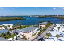 Aerial view of waterfront property with multiple buildings, pool, and lush landscaping at 2375 N Beach Rd # 2B, Englewood, FL 34223