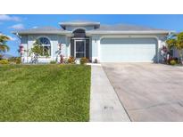 Charming single-story home with well-manicured lawn and two-car garage at 170 Long Meadow Ln, Rotonda West, FL 33947