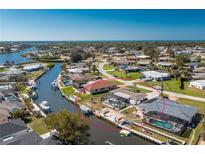 Waterfront home featuring boat dock, screened lanai with pool, and easy access to the open water at 1910 Greenlawn Dr, Englewood, FL 34223