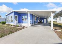 Charming home featuring a covered carport and well-maintained landscaping at 6347 Oriole Blvd, Englewood, FL 34224