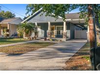 Gray house with a front porch, walkway, and driveway at 1314 E Knollwood St, Tampa, FL 33604