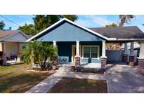 Charming craftsman style home with a welcoming front porch and landscaped yard at 1314 E Knollwood St, Tampa, FL 33604