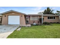 Single-story house with a single-car garage and neat landscaping at 5810 8Th Ave, New Port Richey, FL 34652