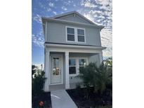 Two-story light gray house with white front door and landscaping at 184 Eagleston Ln, Lakewood Rch, FL 34240