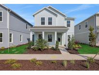 Charming two-story home with a welcoming front porch and landscaped yard at 9039 Duany Ln, Lakewood Ranch, FL 34240