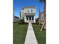 Two-story craftsman home with gray siding, white trim, and walkway at 9019 Rothman Ln, Lakewood Ranch, FL 34240