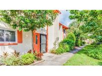 Inviting condo exterior with landscaped walkway and lush greenery at 1655 58Th S Ter # 3, St Petersburg, FL 33712