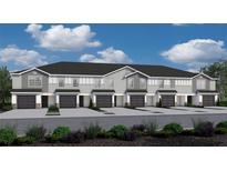 Three-story townhouses with gray siding, dark garages, and landscaping at 2771 Walden Town Cir, Plant City, FL 33566