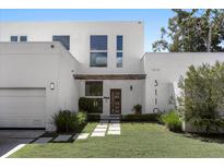 Modern two-story home with white exterior and landscaped lawn at 3110 W Napoleon Ave, Tampa, FL 33611