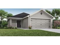 One-story home with gray exterior, two-car garage, and landscaping at 6015 Mangrove Creek Rd, Wimauma, FL 33598