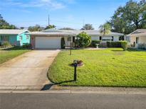 Charming single Gathering home featuring a well-maintained front lawn and a two car garage at 2167 Timber Ln, Clearwater, FL 33763