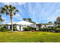 Single-story home with carport and lush landscaping at 266 Cerromar S Way # 55, Venice, FL 34293
