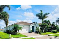 Single-story home with a two-car garage and landscaping at 11684 Renaissance Blvd, Venice, FL 34293