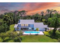 Aerial view of single-Gathering home with pool and private lake at 5885 Denison Dr, Venice, FL 34293