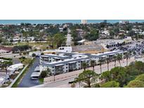 Aerial view of a condo building near the beach with parking and nearby businesses at 708 Tamiami S Trl # 308, Venice, FL 34285