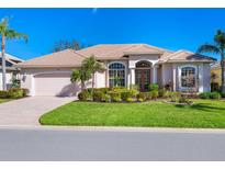 Single-story home with landscaped lawn, two-car garage, and attractive facade at 1078 Tuscany Blvd, Venice, FL 34292