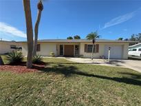 Ranch-style home with a well-maintained lawn and driveway at 261 Malvern Dr, Venice, FL 34293