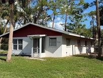 Ranch style home with red roof and large yard at 506 Kenwood Ave, Nokomis, FL 34275