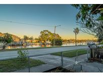 Scenic waterfront view of a peaceful canal with boats and lush greenery at 3911 Sunrise S Dr, St Petersburg, FL 33705