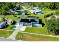 Aerial view of single-story home with solar panels, pool, and spacious yard at 4625 Pan American Blvd, North Port, FL 34287