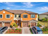 Attractive two-story townhome with a two-car garage and landscaped front yard at 20428 Lagente Cir, Venice, FL 34293