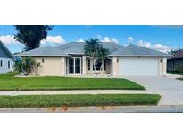 Single-story house with a two-car garage and well-maintained lawn at 338 Woodvale Dr, Venice, FL 34293