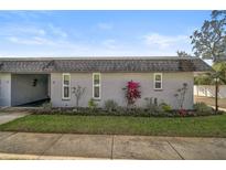 Gray exterior condo with well-manicured landscaping and a paved walkway at 4160 Fruitville Rd # 14, Sarasota, FL 34232