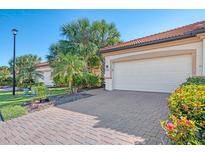 White double garage door with paver driveway at 9847 Haze Dr, Venice, FL 34292