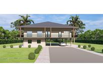 Two-story elevated home with carport and tropical landscaping at 0 Westview Dr, Osprey, FL 34229