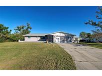 Ranch-style home with a large yard and screened porch at 1358 Leawood Rd, Englewood, FL 34223