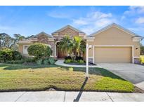 Beautiful one-story home with stone accents and a lush lawn at 19718 Cobblestone Cir, Venice, FL 34292