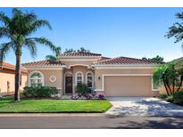 Attractive single-story home with a tile roof and landscaped front yard at 305 Rio Terra, Venice, FL 34285