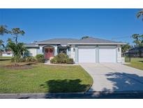 Two-car garage, light blue house with nicely landscaped lawn at 108 Hourglass Dr, Venice, FL 34293