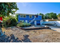 Charming blue house with boat and landscaped yard at 113 Colonia W Ln, Nokomis, FL 34275