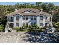 Two-story building with tile roofs, balconies, and parking at 121 Preserve Pl # A, Nokomis, FL 34275