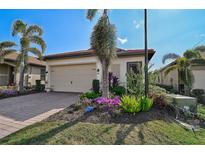 Single-story home with attached garage and landscaped front yard at 125 Soliera St, Nokomis, FL 34275