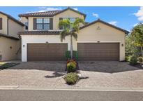 Two-story townhome with two-car garage and attractive landscaping at 12530 Ghiberti Cir # 102, Venice, FL 34293