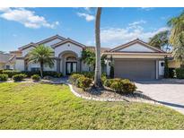 Beautiful one-story home with a tile roof, landscaping, and a two-car garage at 1348 Reserve Dr, Venice, FL 34285