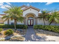 Inviting front entrance with double doors and lush landscaping at 1348 Reserve Dr, Venice, FL 34285