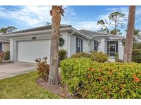 White one-story home with a two-car garage and manicured landscaping at 1647 Lancashire Dr # 1647, Venice, FL 34293
