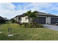 Single-story home with attached garage and landscaped front yard at 2009 Mackerel St, Port Charlotte, FL 33953