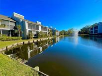 Community waterfront view, featuring multiple buildings and lush landscaping at 259 Fenwick Dr # 40, Venice, FL 34285
